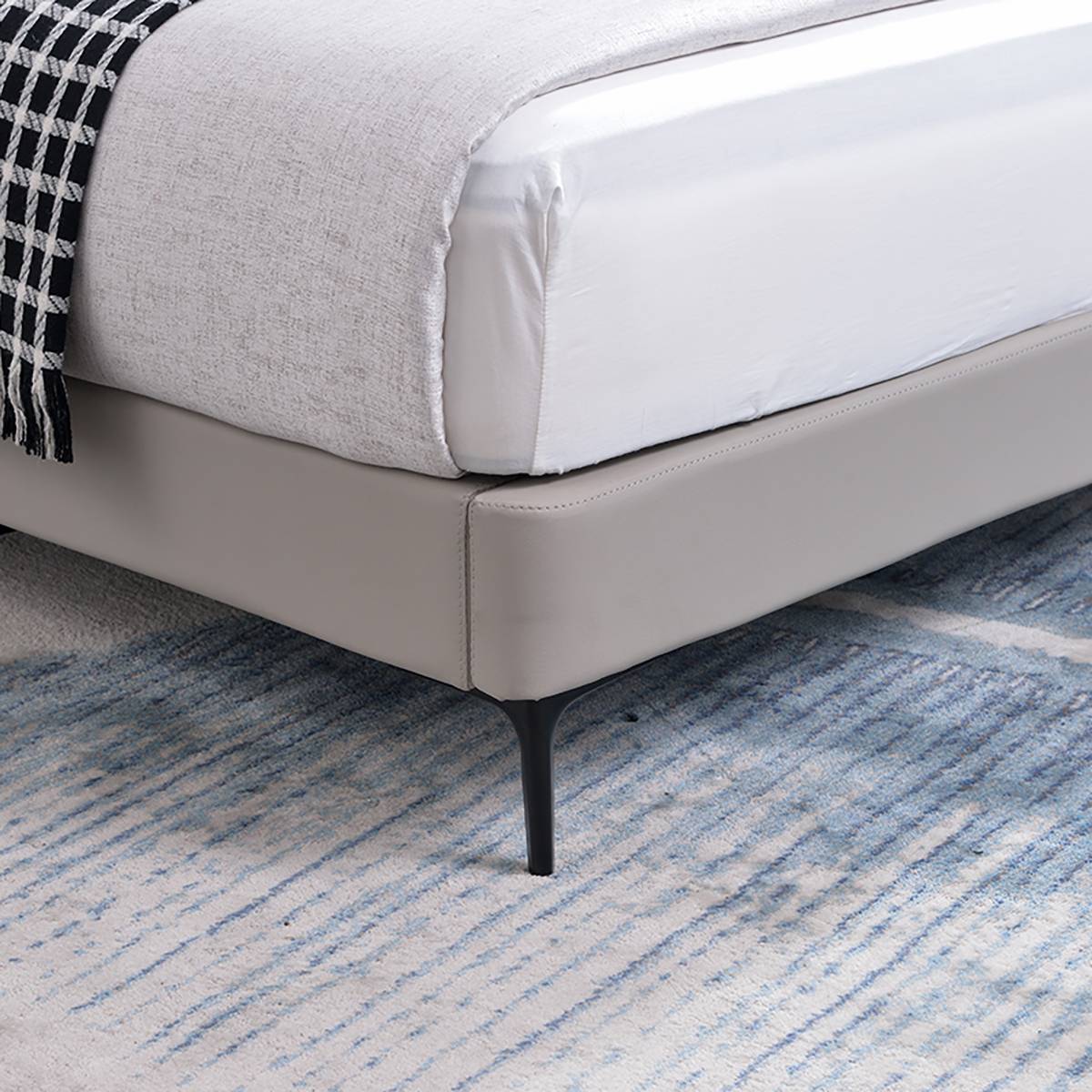 Close-up detail of the bed frame corner and metal leg