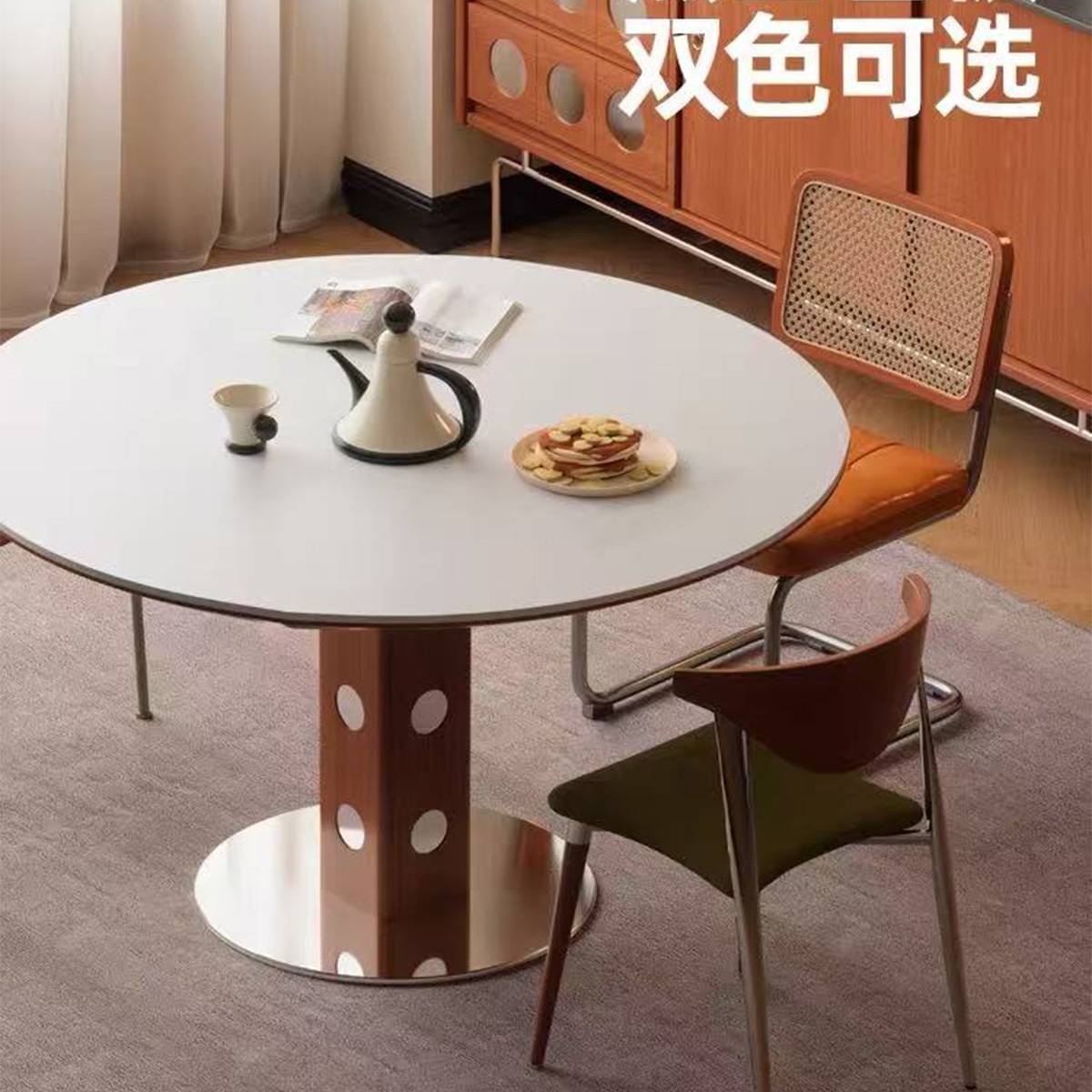 White round dining table with polka dot wooden base and stainless steel feet, accompanied by dining chairs