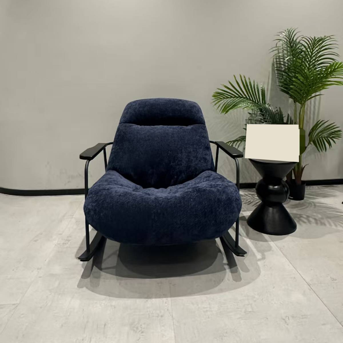 Front view of a blue velvet rocking lounge chair