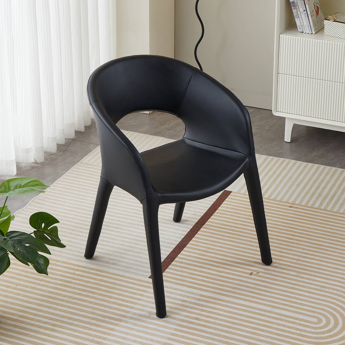 Black modern lounge chair with curved backrest