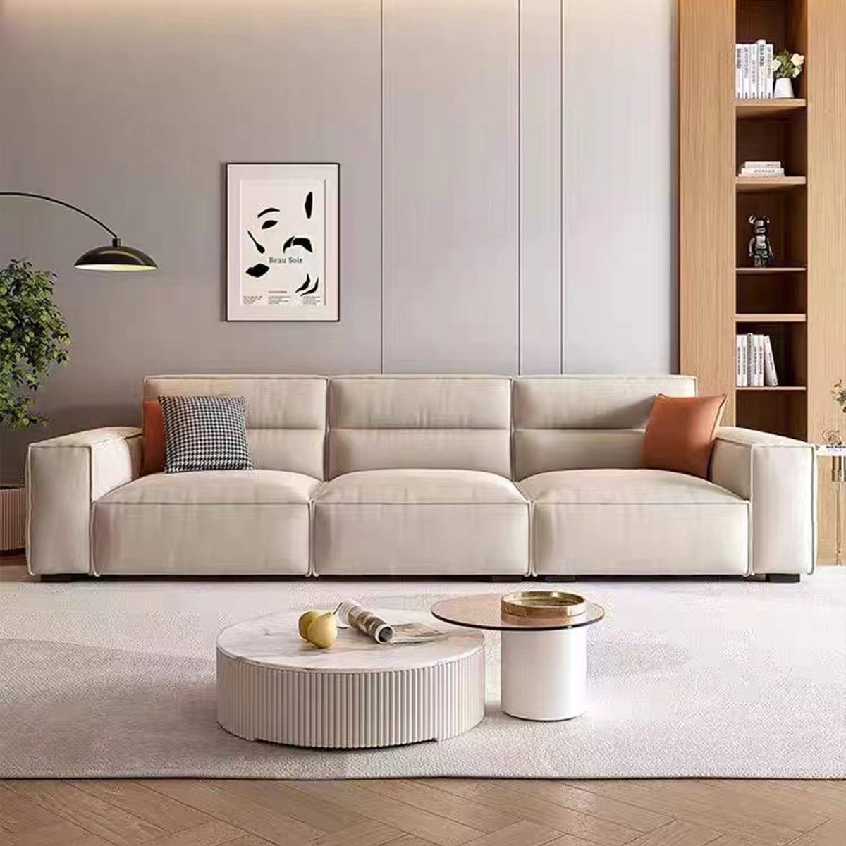 Brown leather straight sofa with checkered pillows in a showroom setting