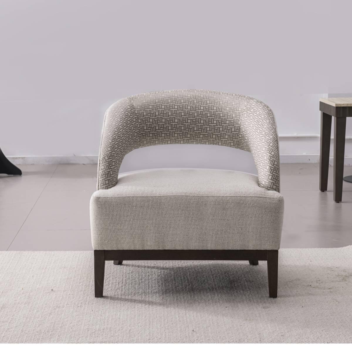 Front view of a modern lounge chair showing the curved backrest and solid seat cushion