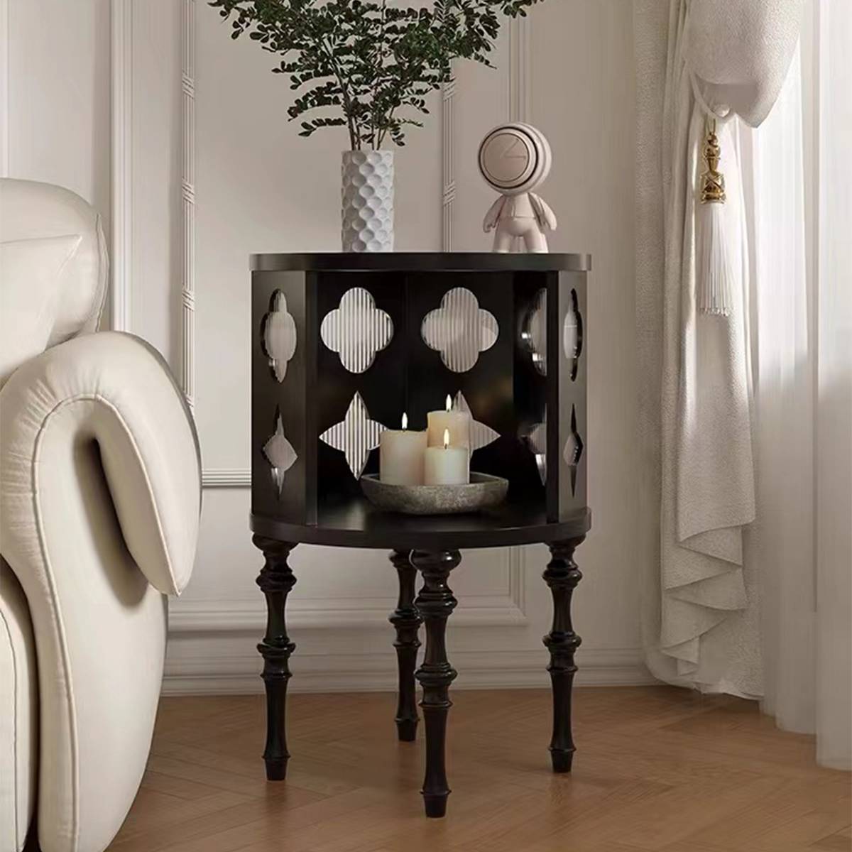 Side table with candles inside the lower shelf and a vase on top
