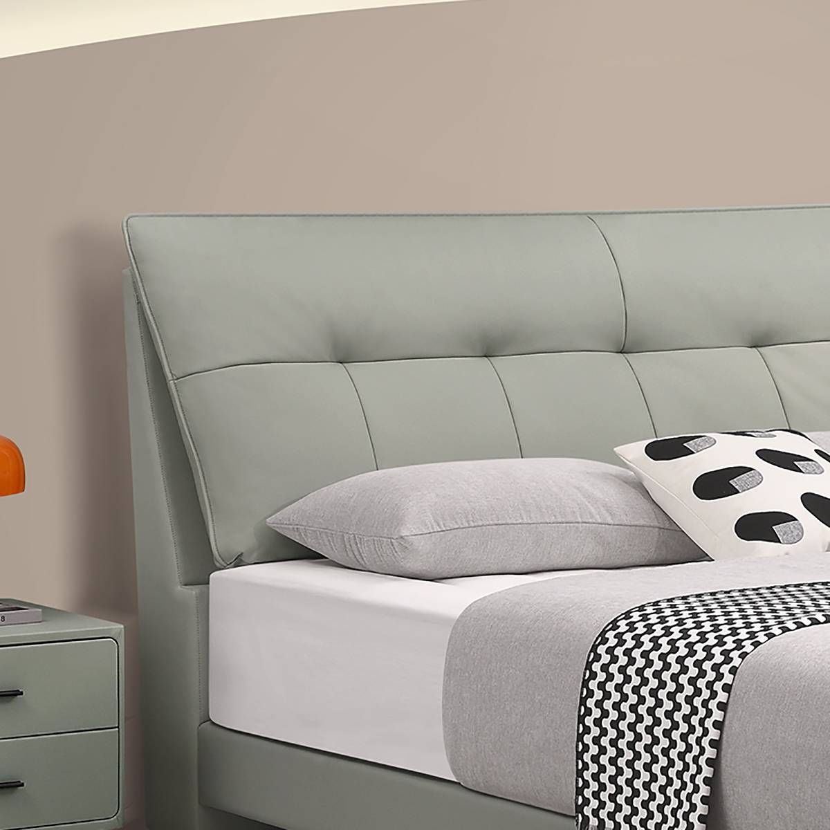 Close-up detail of the tufted headboard and pillows