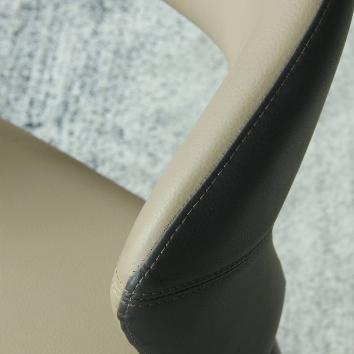 Detail shot of the stitching and material texture on the chair backrest