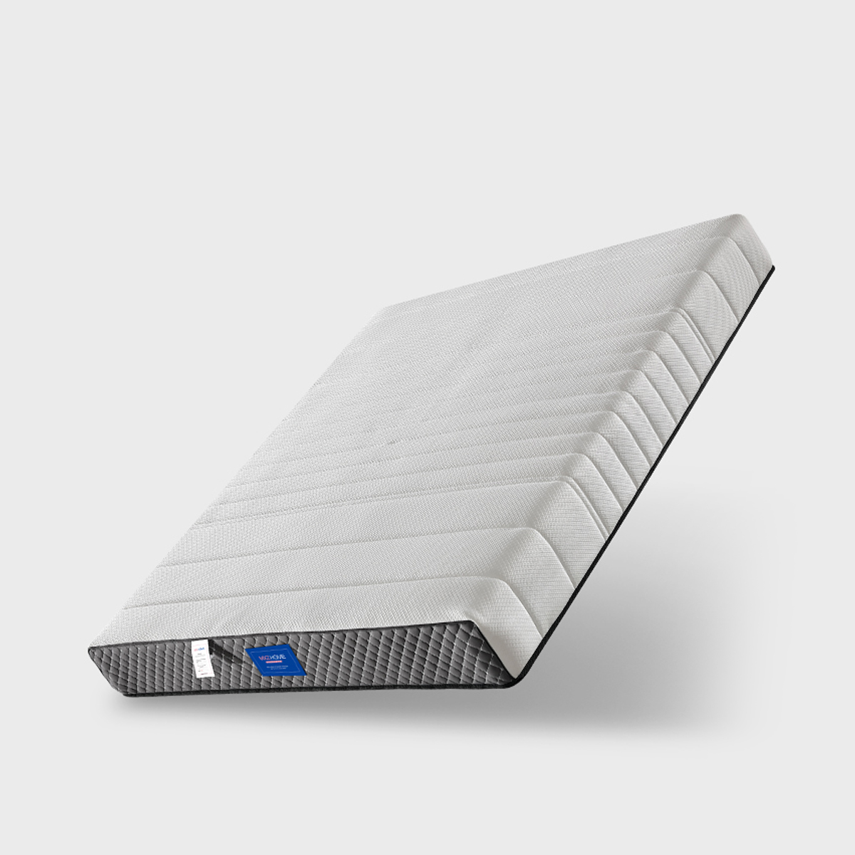 Angled view of mattress showing profile and side tags