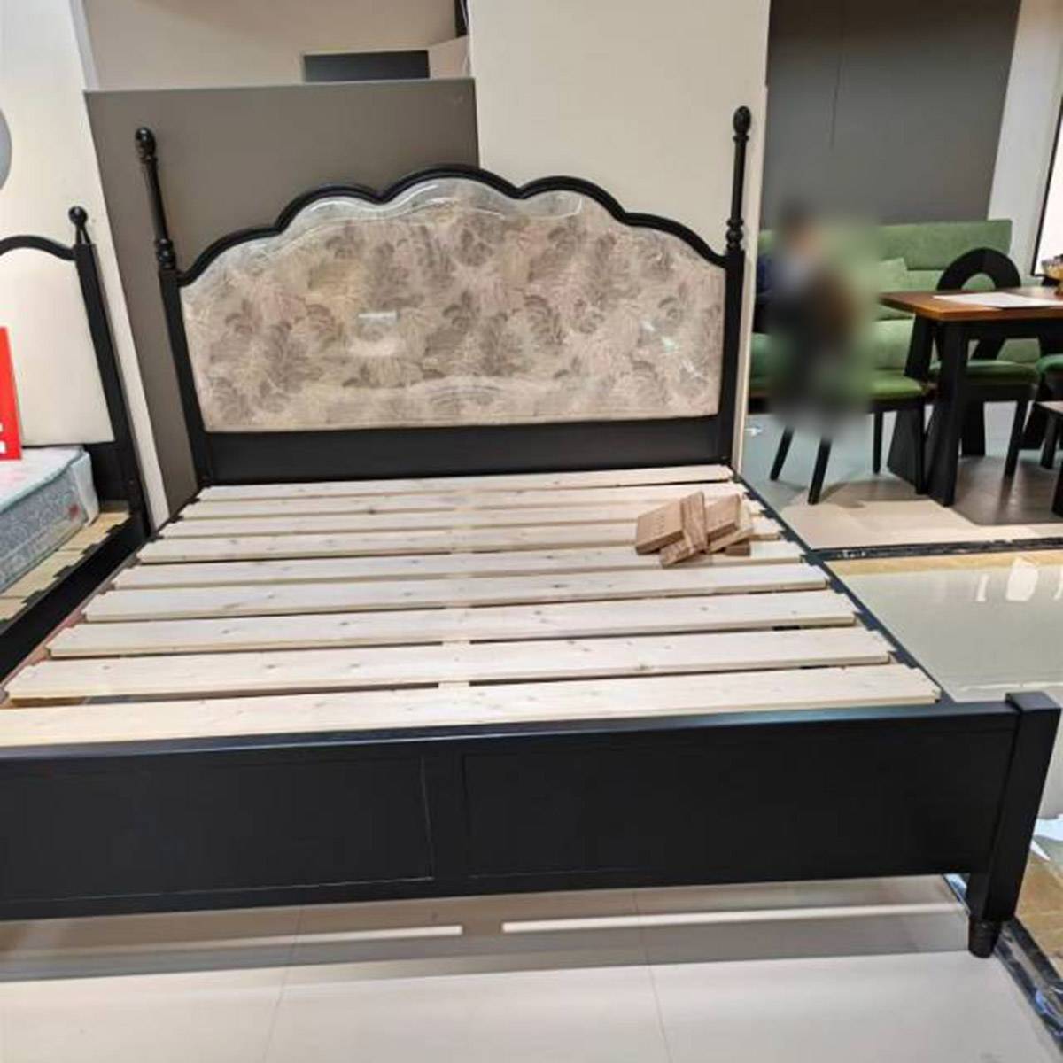 Bed frame showing wooden slats and headboard construction