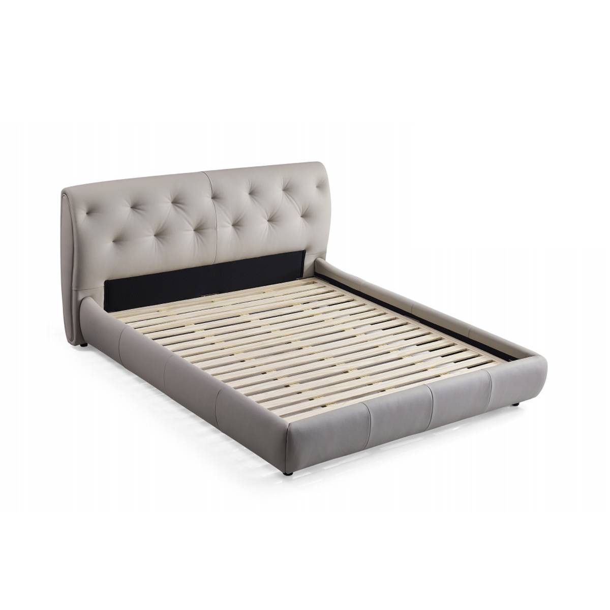 Side view of a grey upholstered bed with a tufted headboard and wooden slat base
