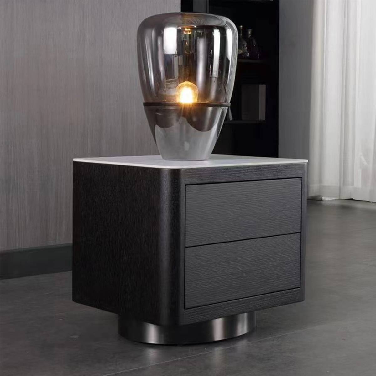 Side view of the bedside table with a glass lamp on top