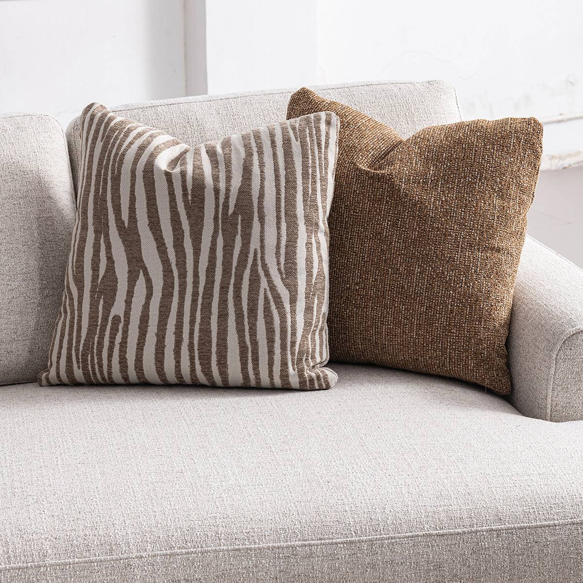 Close-up of the Victor Fabric Sofa showing the texture of the fabric and decorative pillows