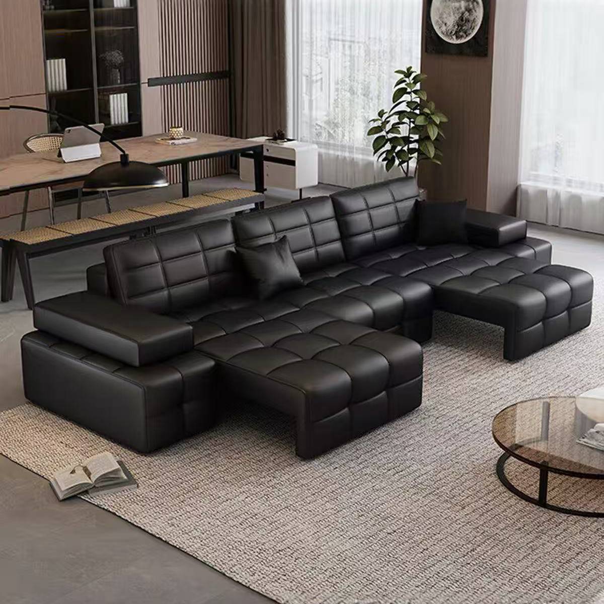 Full view of the black sectional sofa bed in a spacious living room setting