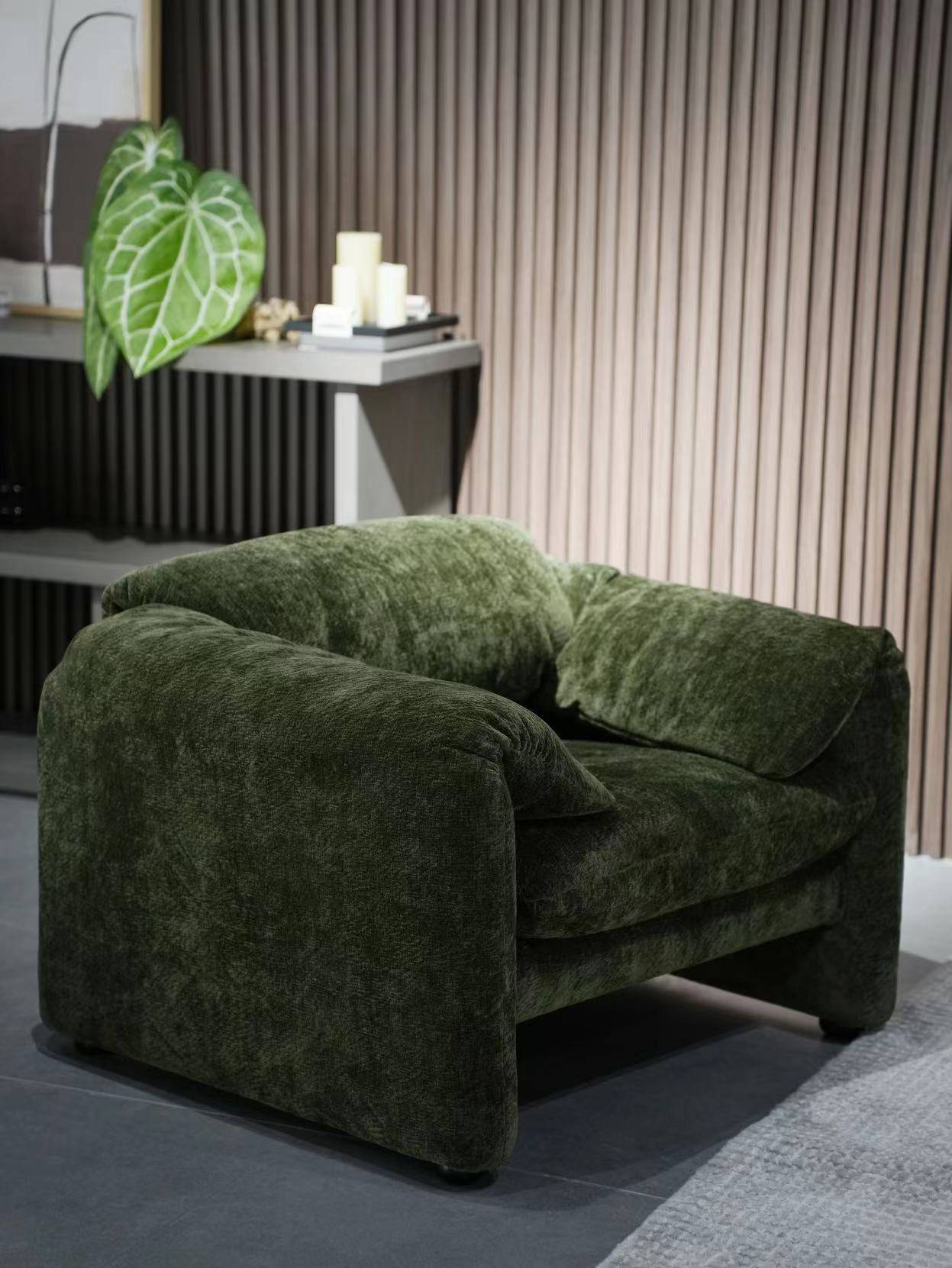 Green velvet lounge chair in a modern living room setting