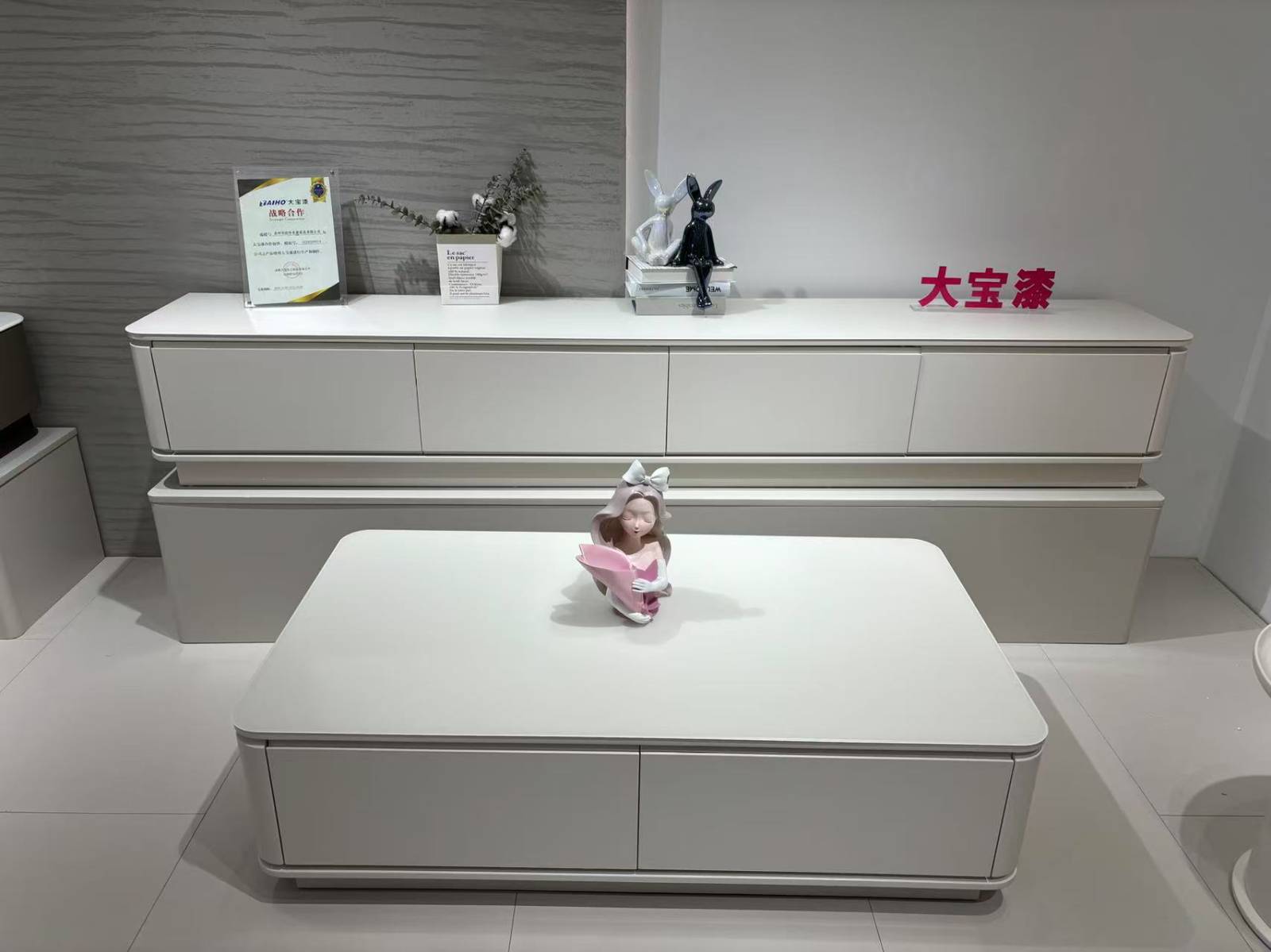 White TV console with decorative items on top