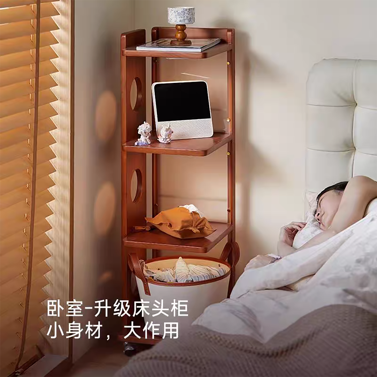Side cabinet used as a bedside table with a tablet and lamp