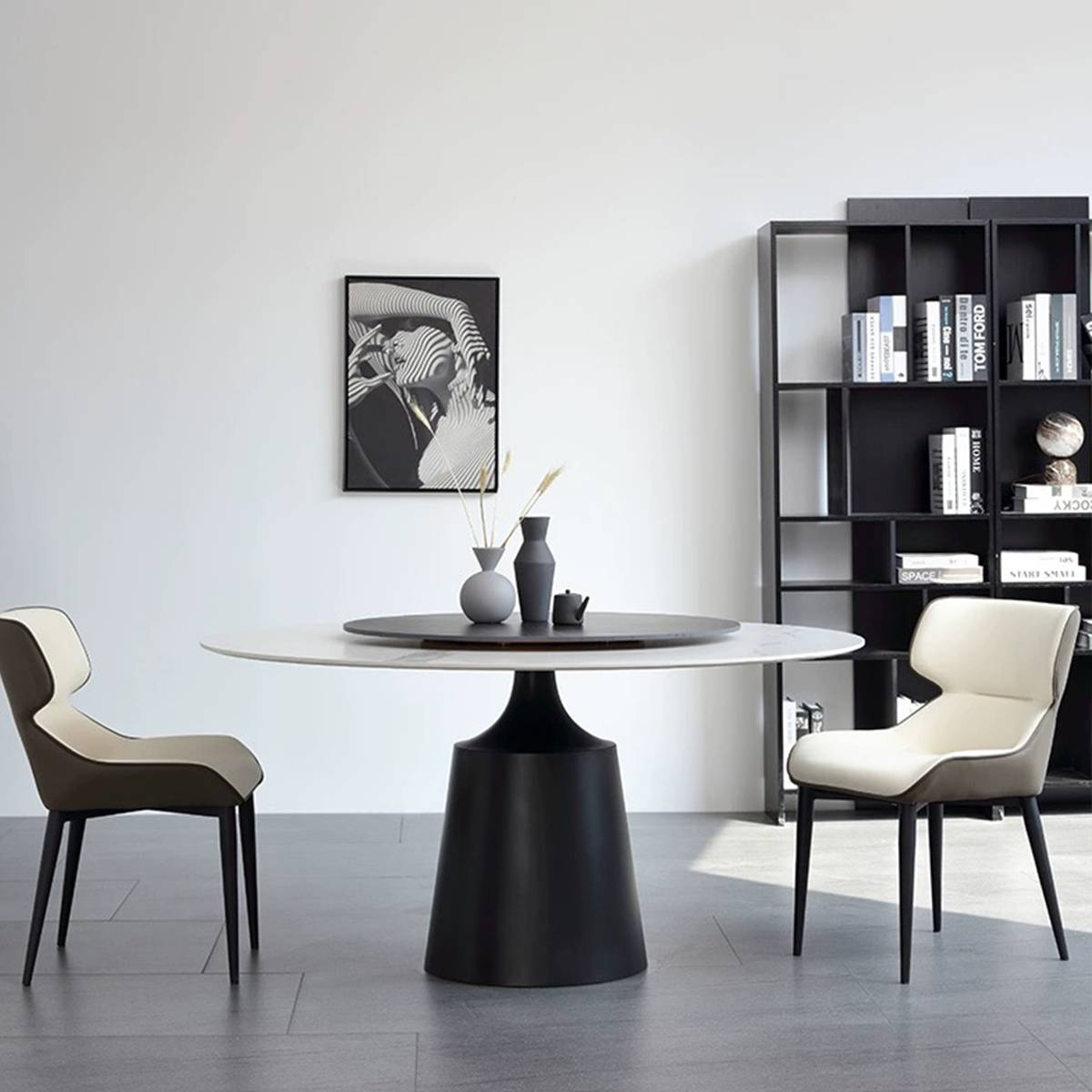 White sintered stone round dining table with black base and cream chairs