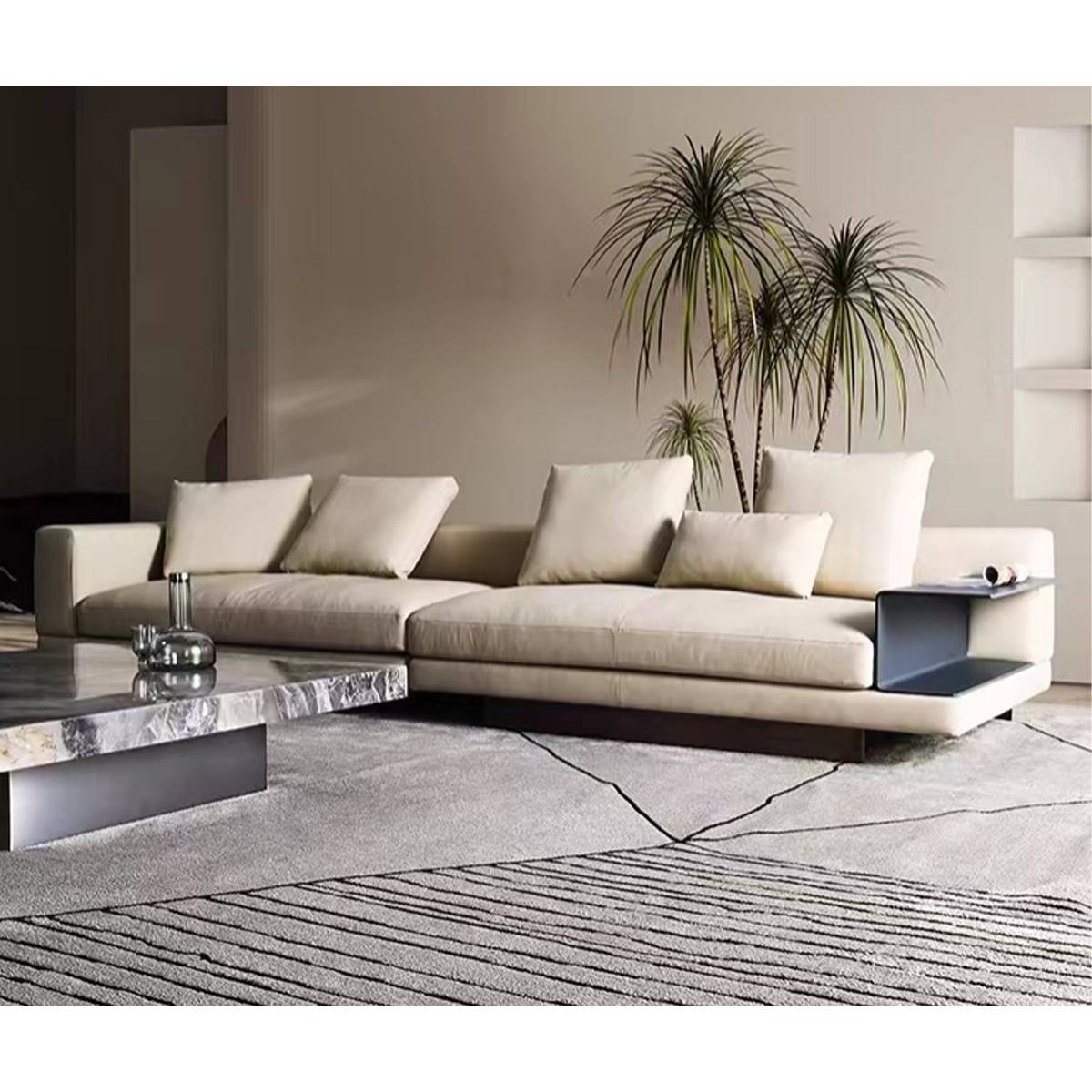 Angled view of the sofa with a marble coffee table and indoor plants.