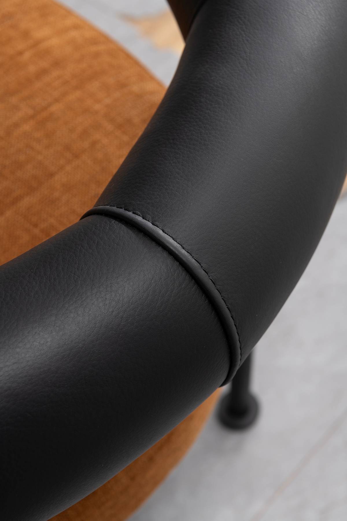 Close-up of the black leather armrest stitching