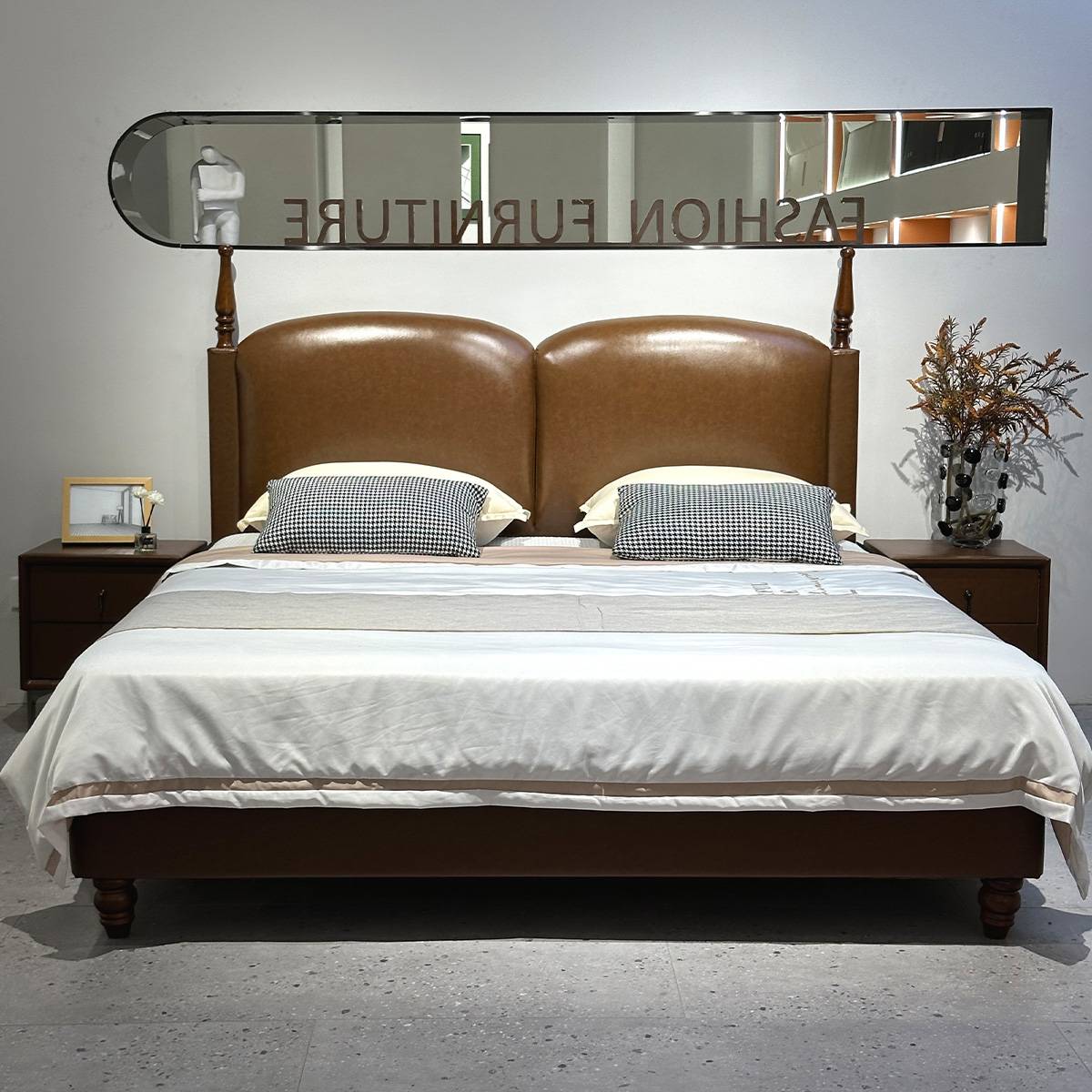 Front view of the bed showing the dual-cushion headboard and checkered pillows