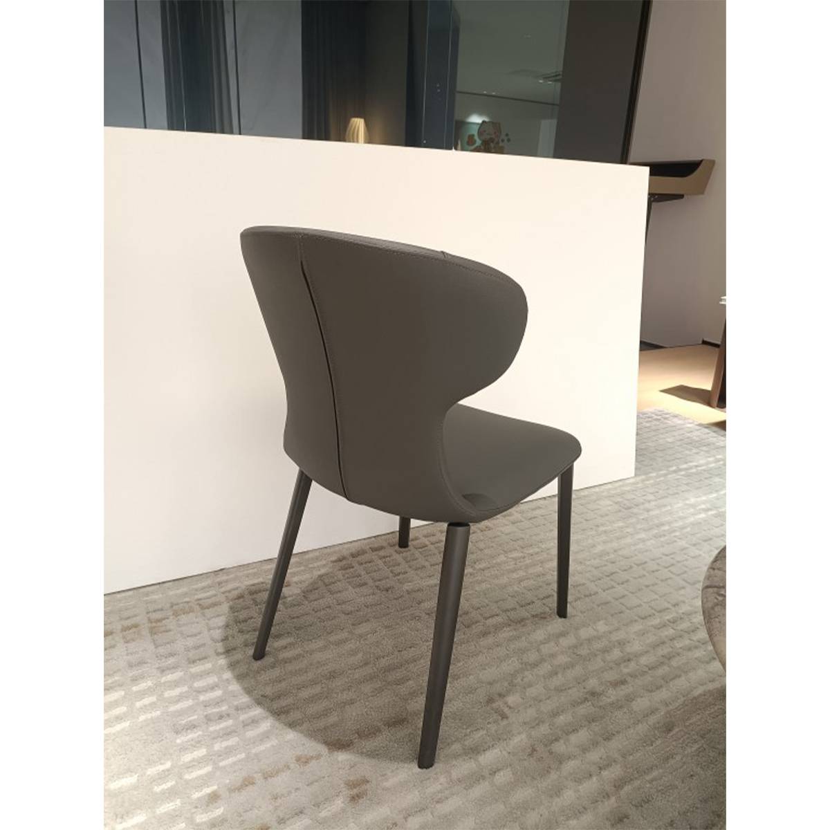 Side profile view of the dark grey dining chair highlighting the curved backrest