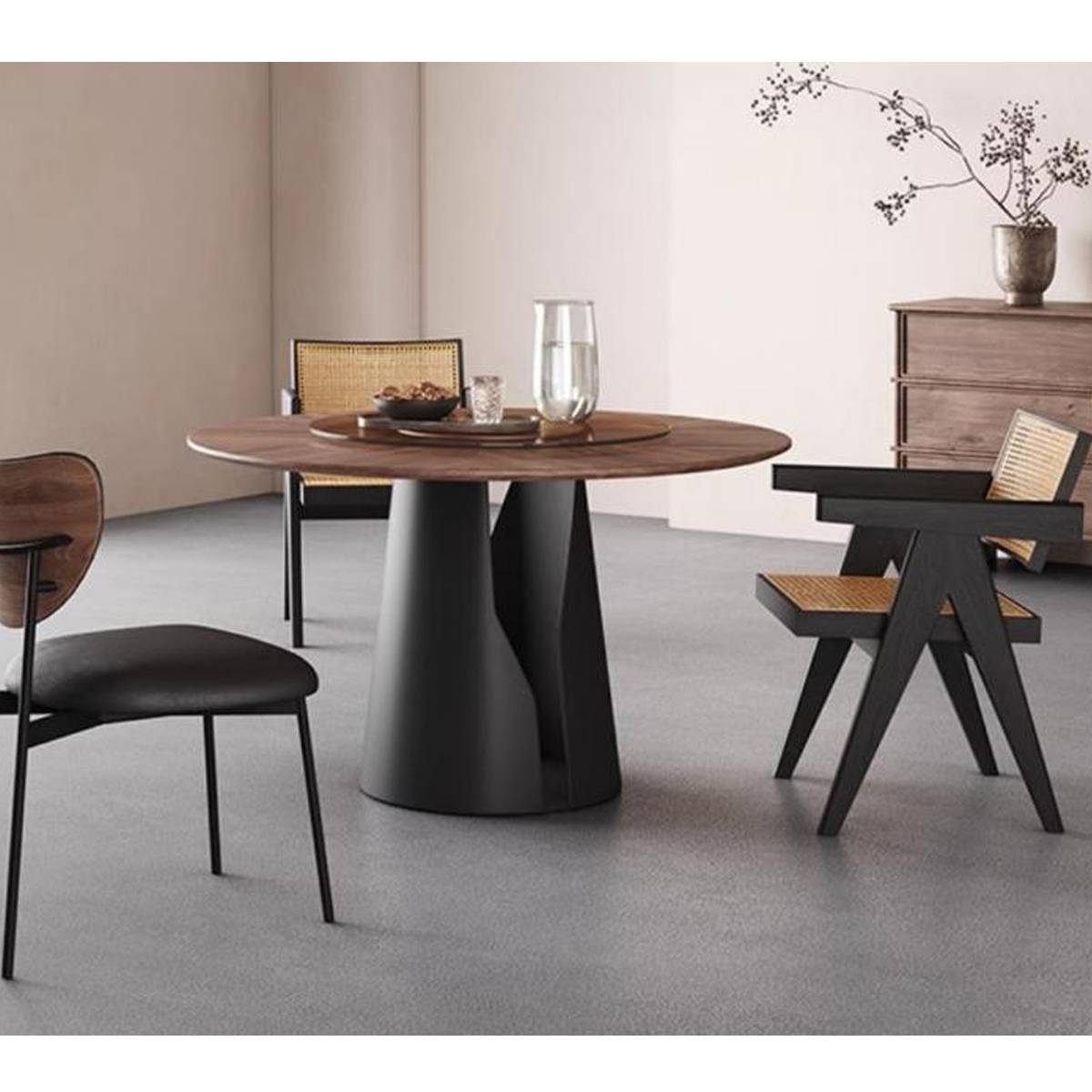 Round dining table with solid wood top and black steel base in a minimalist setting