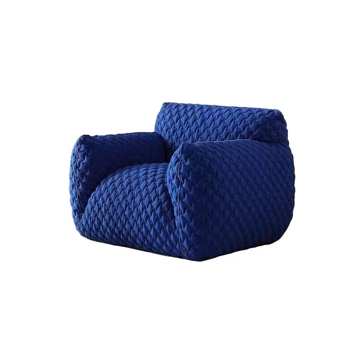 Side view of the blue quilted lounge chair on a white background