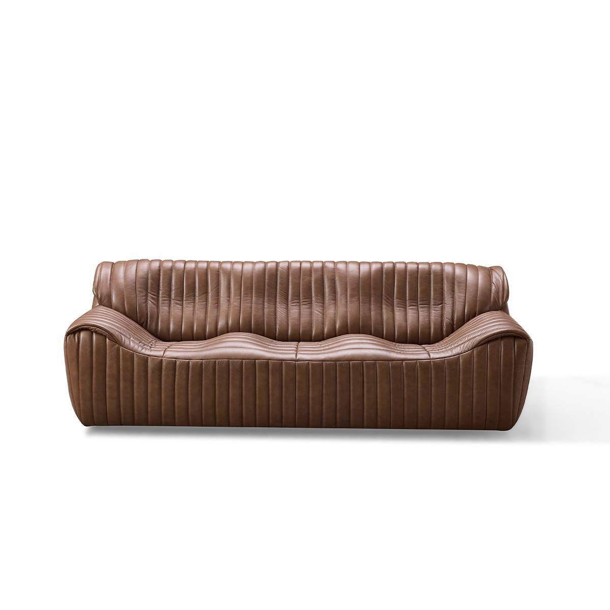 Front view of the brown leather sofa showing the wave design