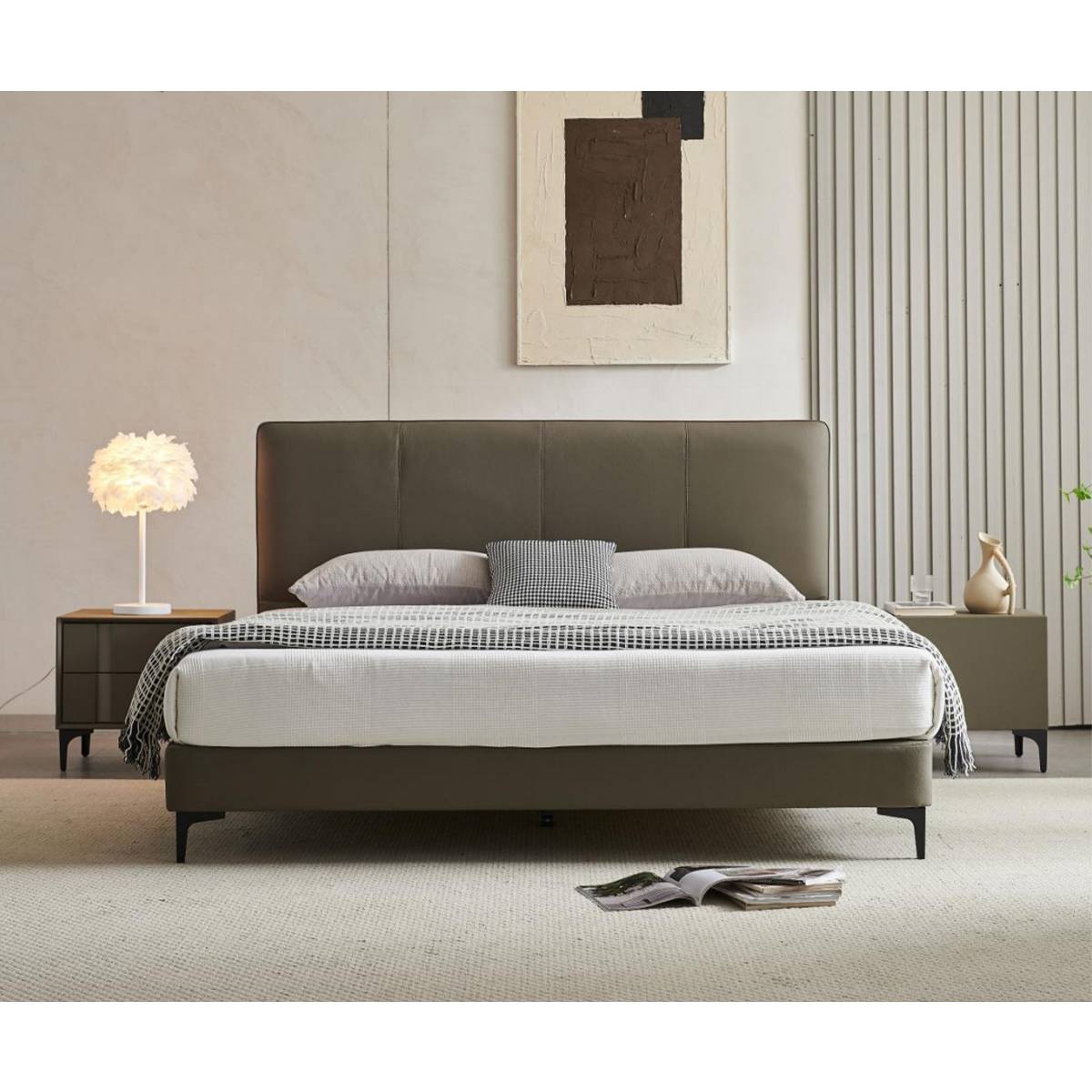 Front view of the upholstered bed with pillows and throw blanket