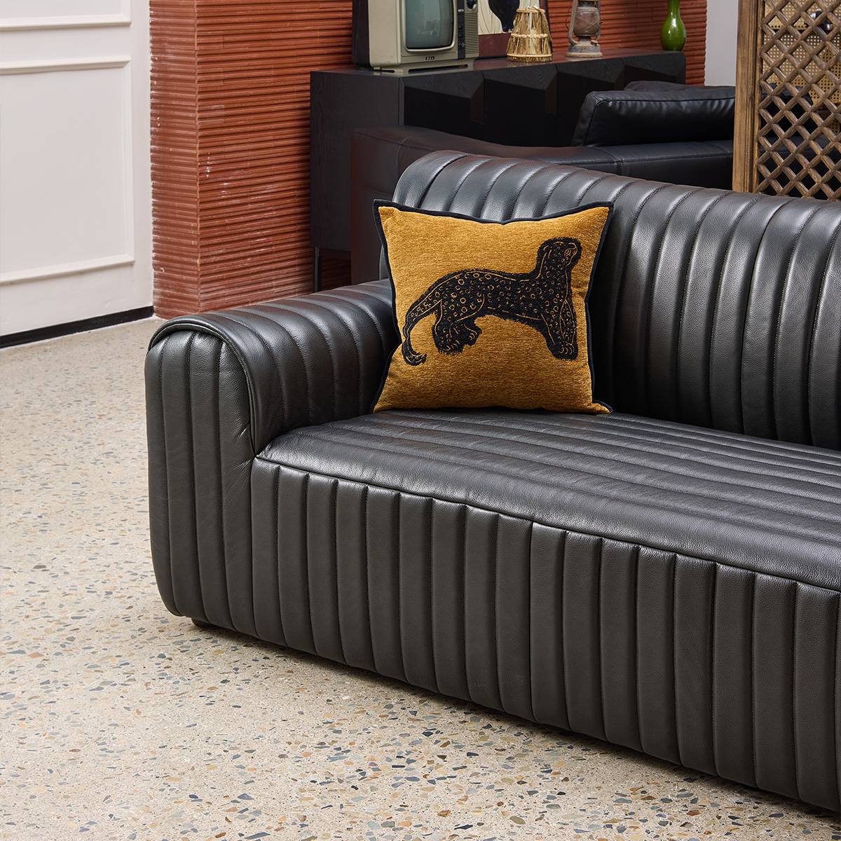 Close up detail of sofa armrest and leather texture in a room setting