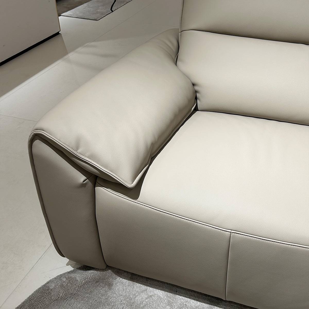Close-up detail of the sofa armrest and eco-leather texture