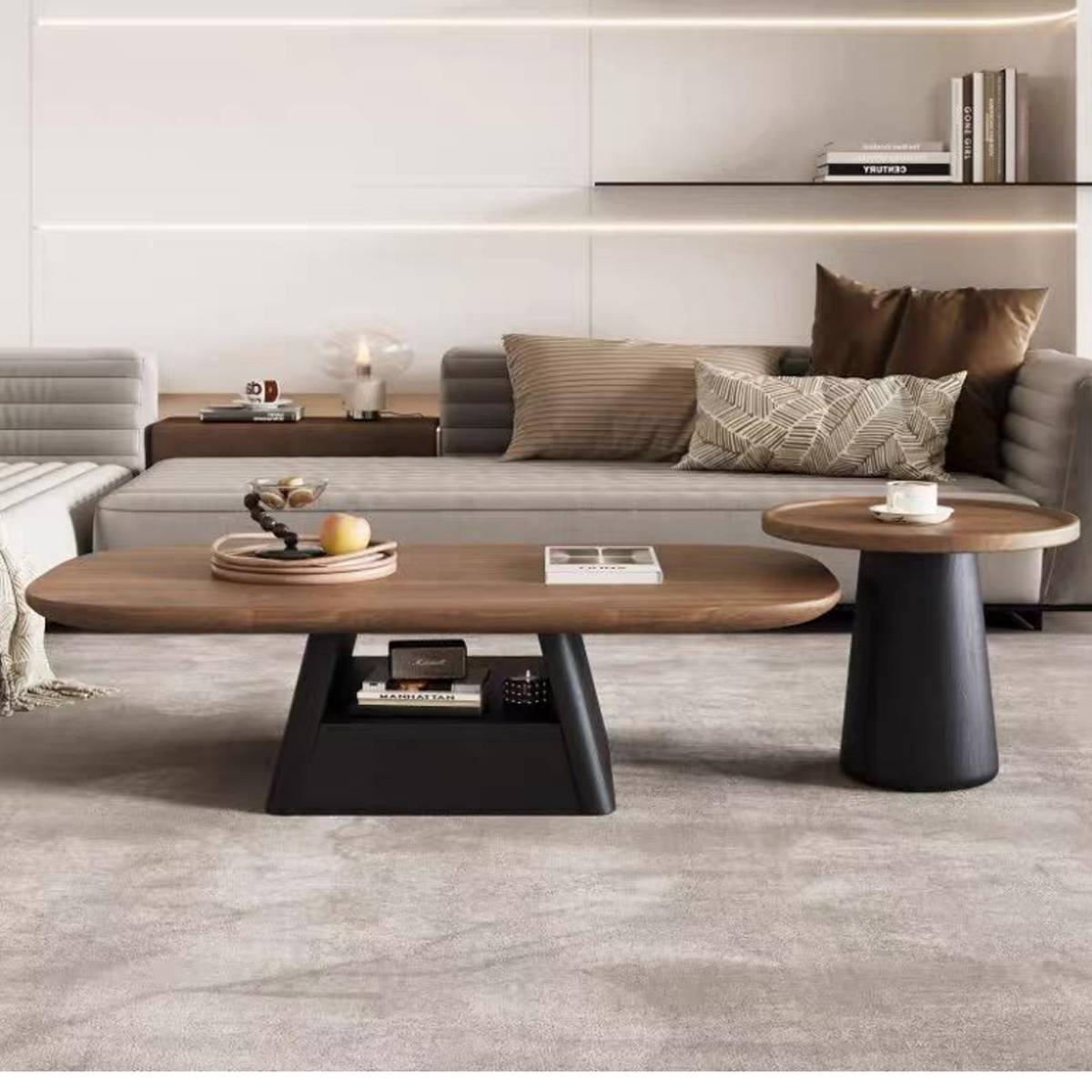 Full view of the coffee table set in a modern living room setting, showing the oval table and round side table.