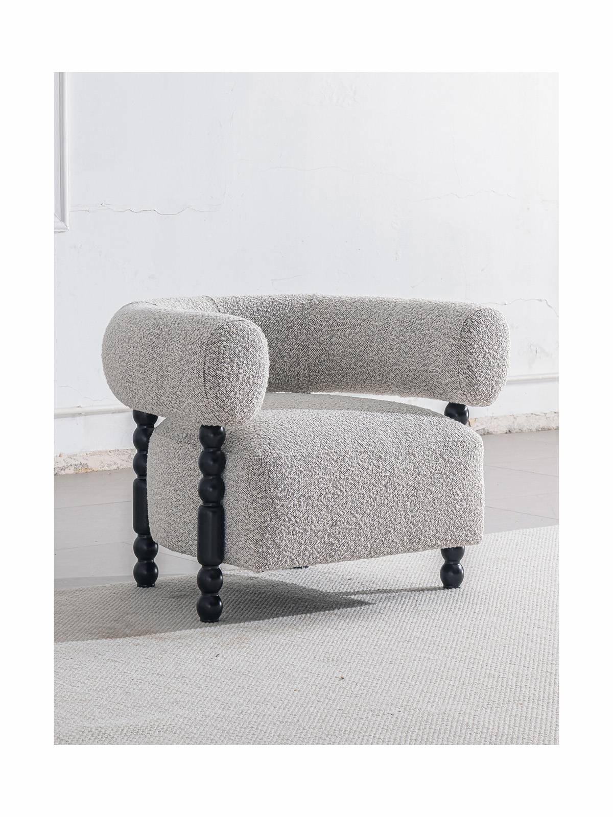 Lounge chair placed in a room setting on a light rug