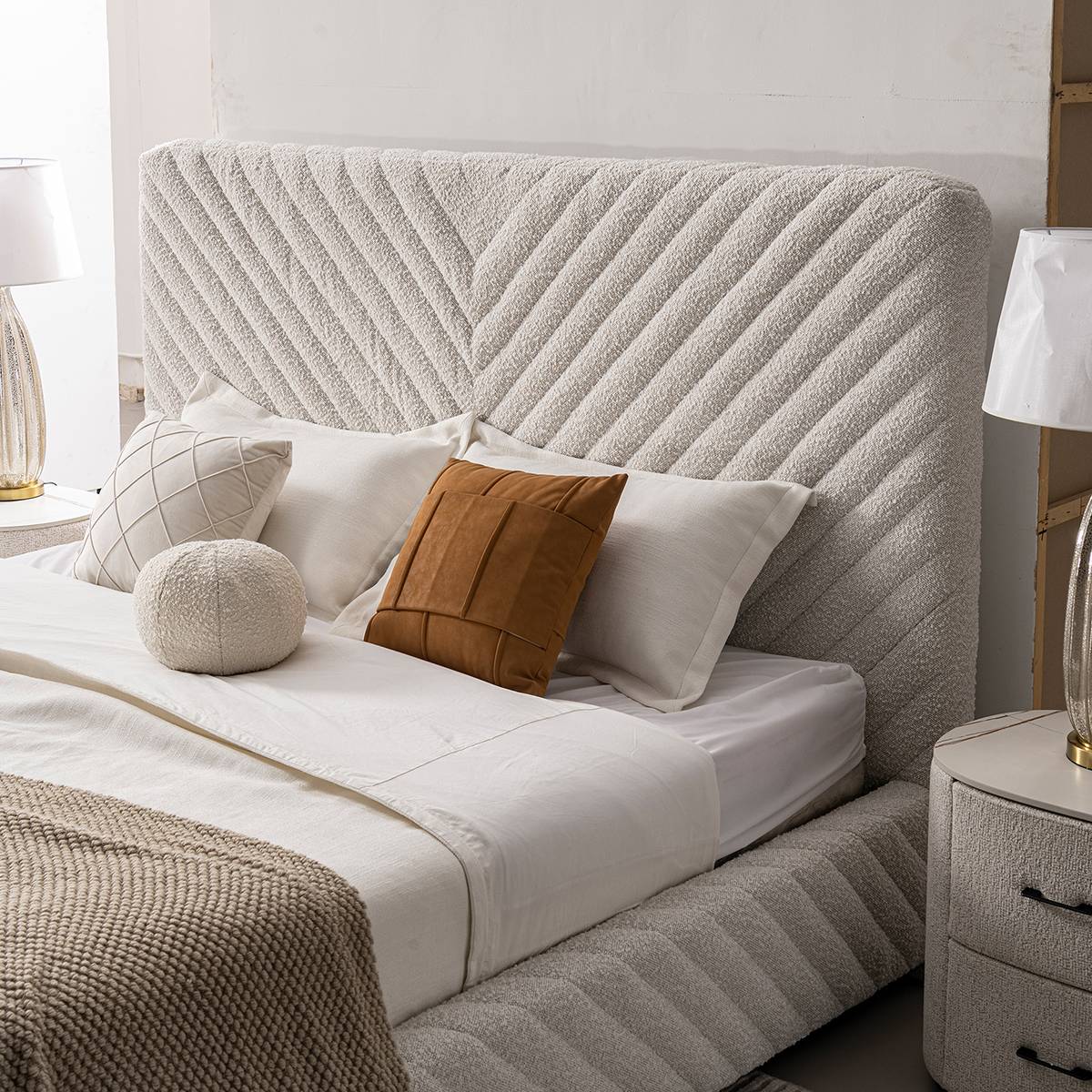 Full view of the MXZ-B upholstered bed with diamond tufting, white bedding, and a brown throw blanket in a modern bedroom setting.