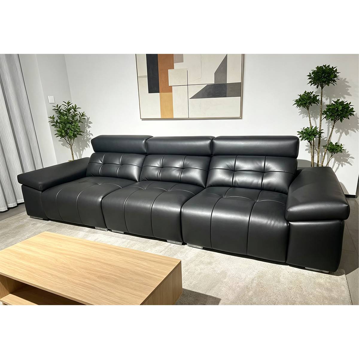 Front view of the black straight sofa with a wooden coffee table in front