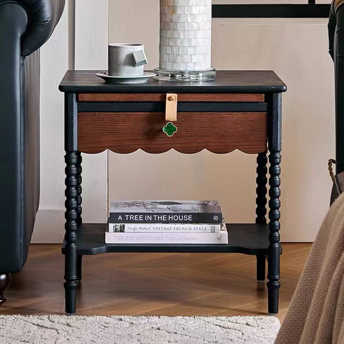 Close-up detail of the wooden drawer with green clover knob and leather strap