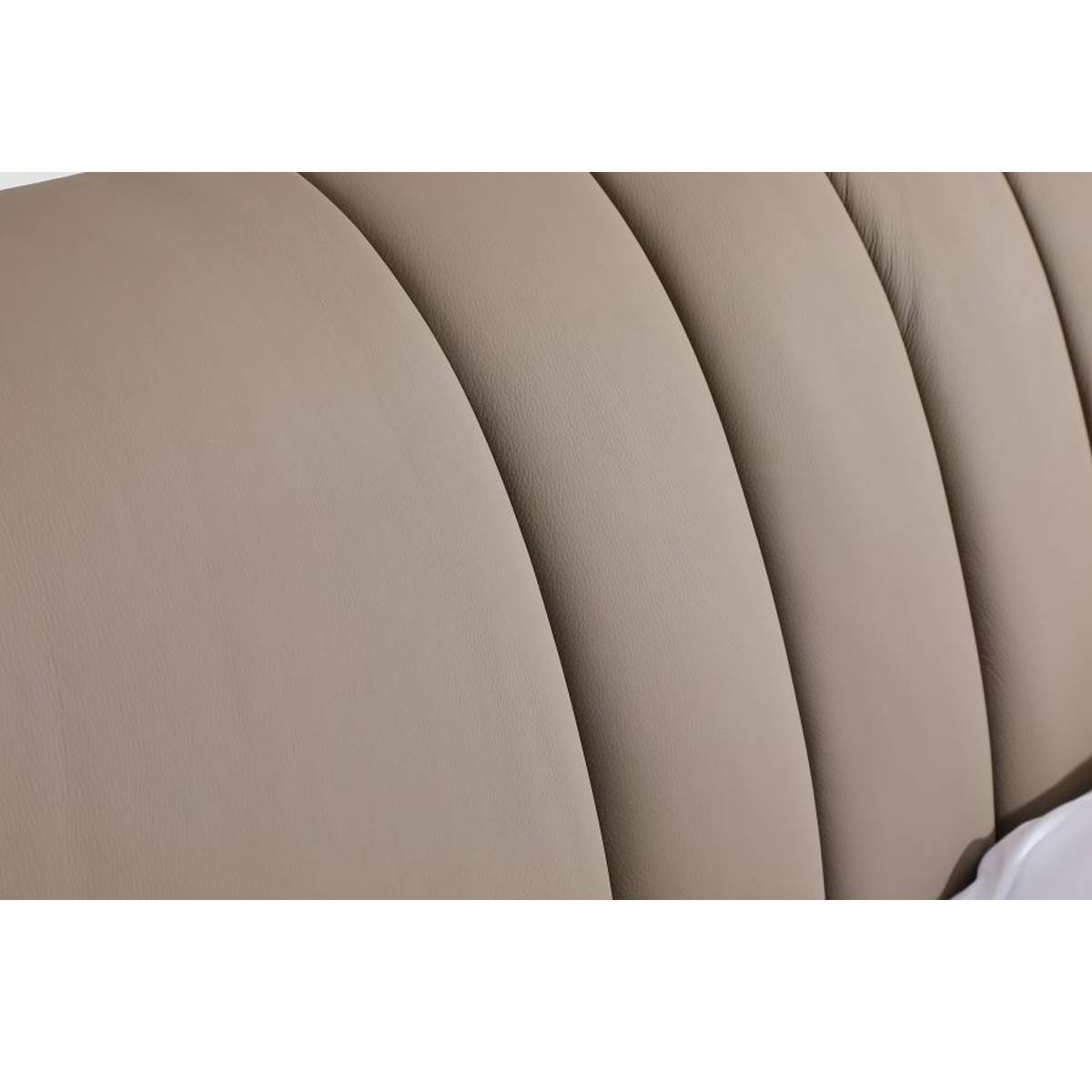 Close-up detail of the tufted genuine leather headboard texture
