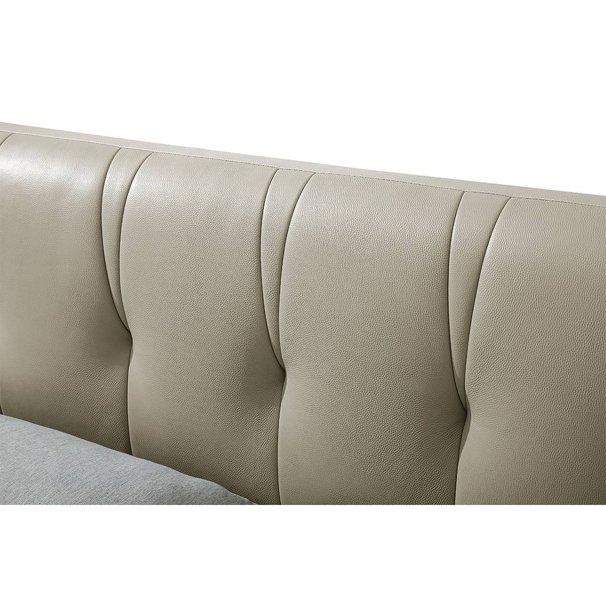 Close-up view of the beige tufted leather headboard showing texture and stitching details