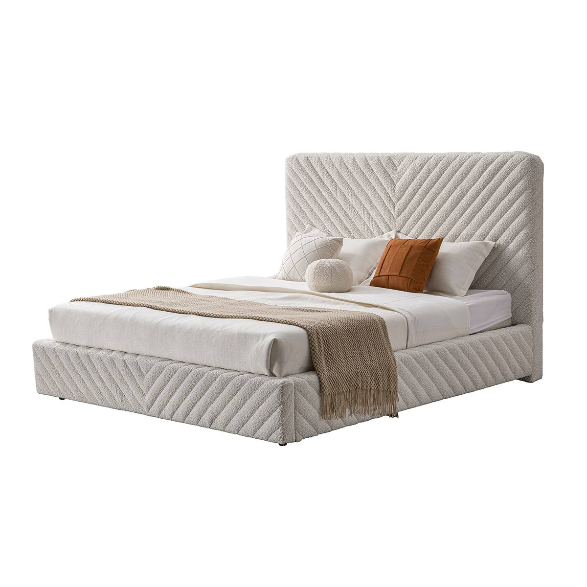 Three-quarter view of the upholstered bed showing the side profile