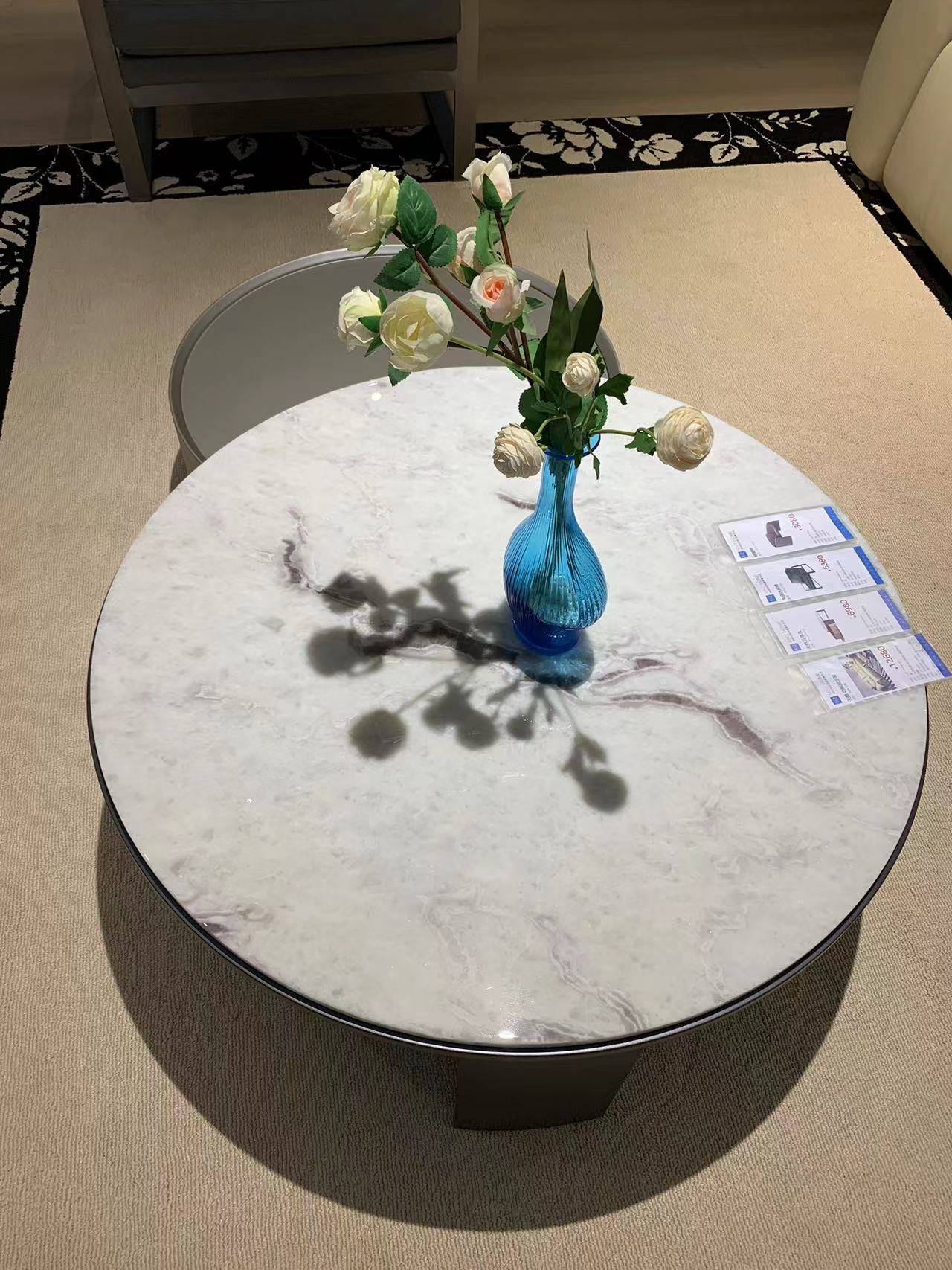 Close-up of the coffee table surface showing the marble texture and product cards.