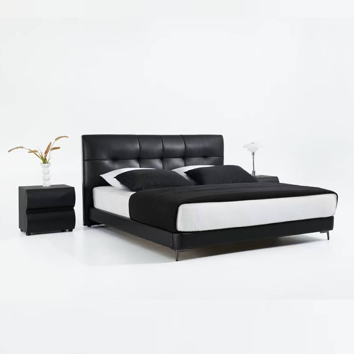 Side view of black leather bed showing profile and nightstand