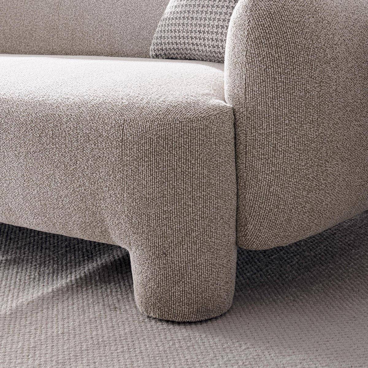 Front view of the Gabu fabric sofa with two patterned pillows