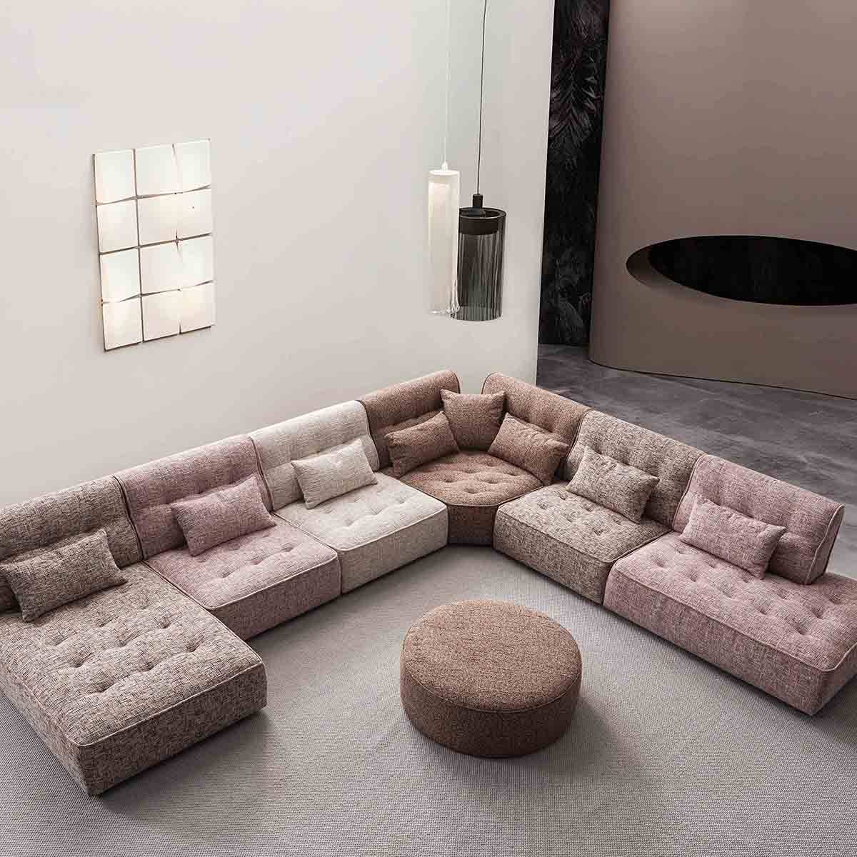 Lifestyle shot of the Kumla sofa in a modern living room setting with a round ottoman