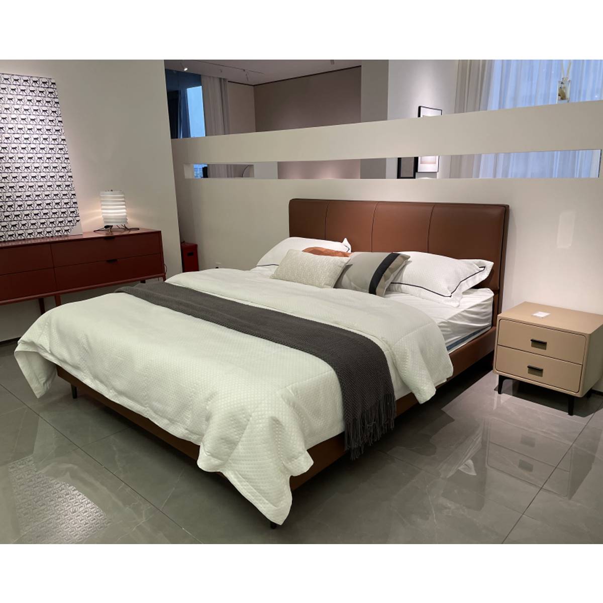 Wide angle view of the bed with bedside table and dresser