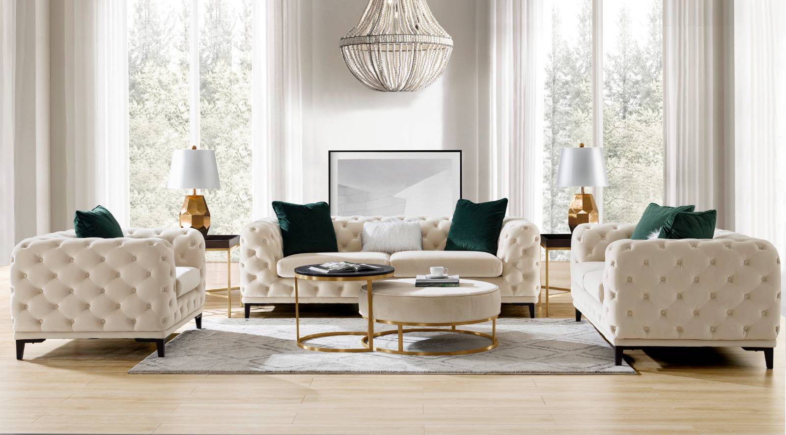 Living room setup featuring a cream tufted sofa, matching armchairs, and gold accents