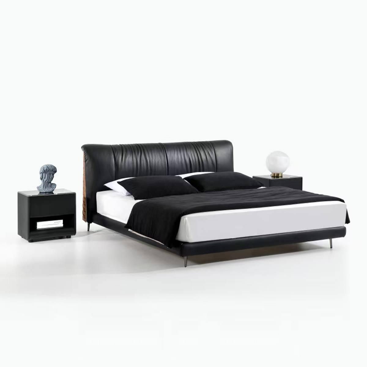 Angled view of the black leather bed showing the headboard and side profile