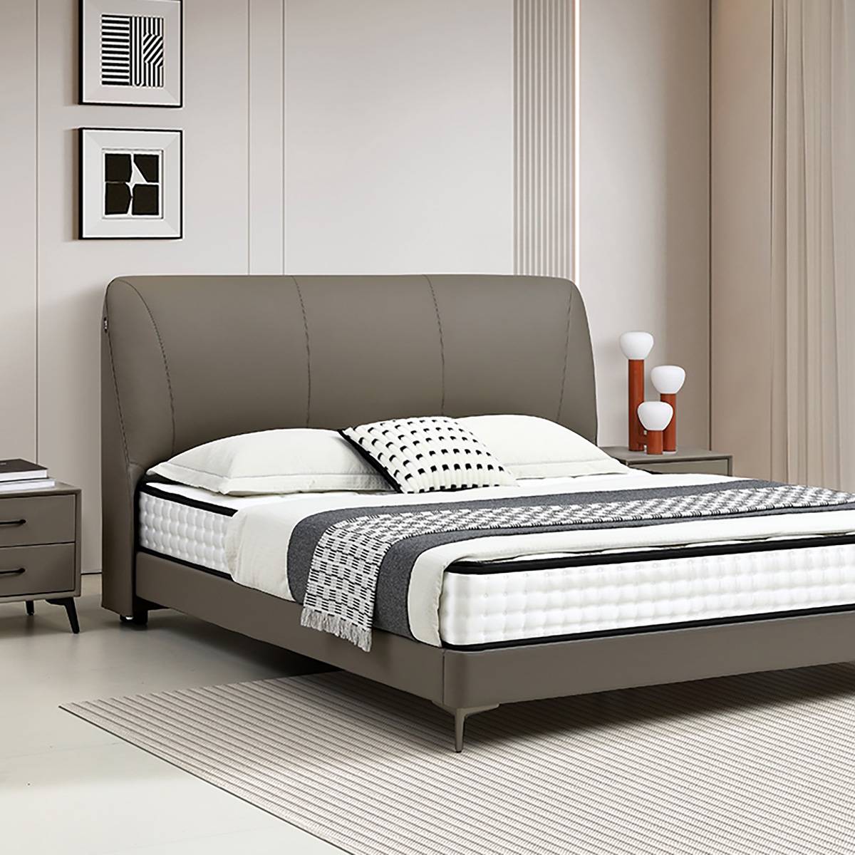Front angle view of the leather bed showing the headboard and bedding