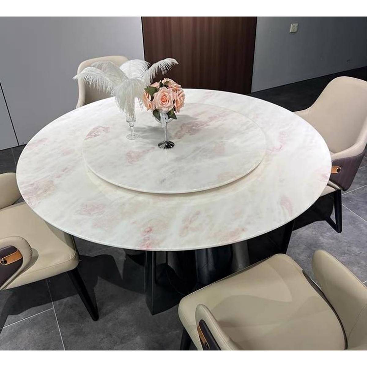 High angle view of the round marble dining table showing the lazy susan and surrounding dining chairs