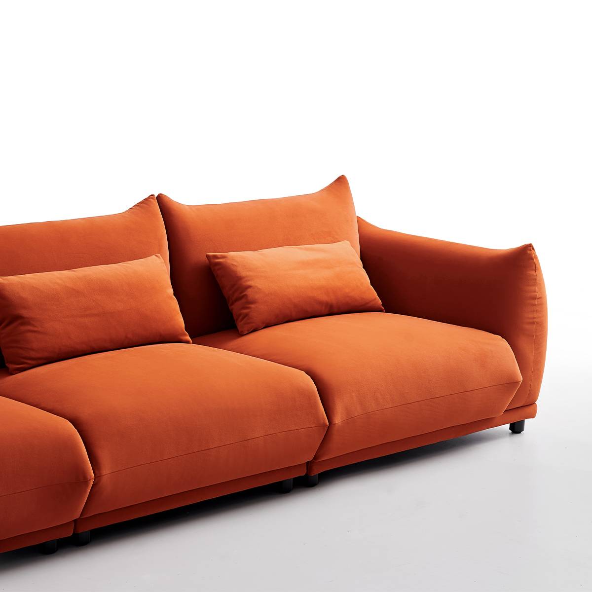 Side angle view of the sofa showing the back cushions and metal legs