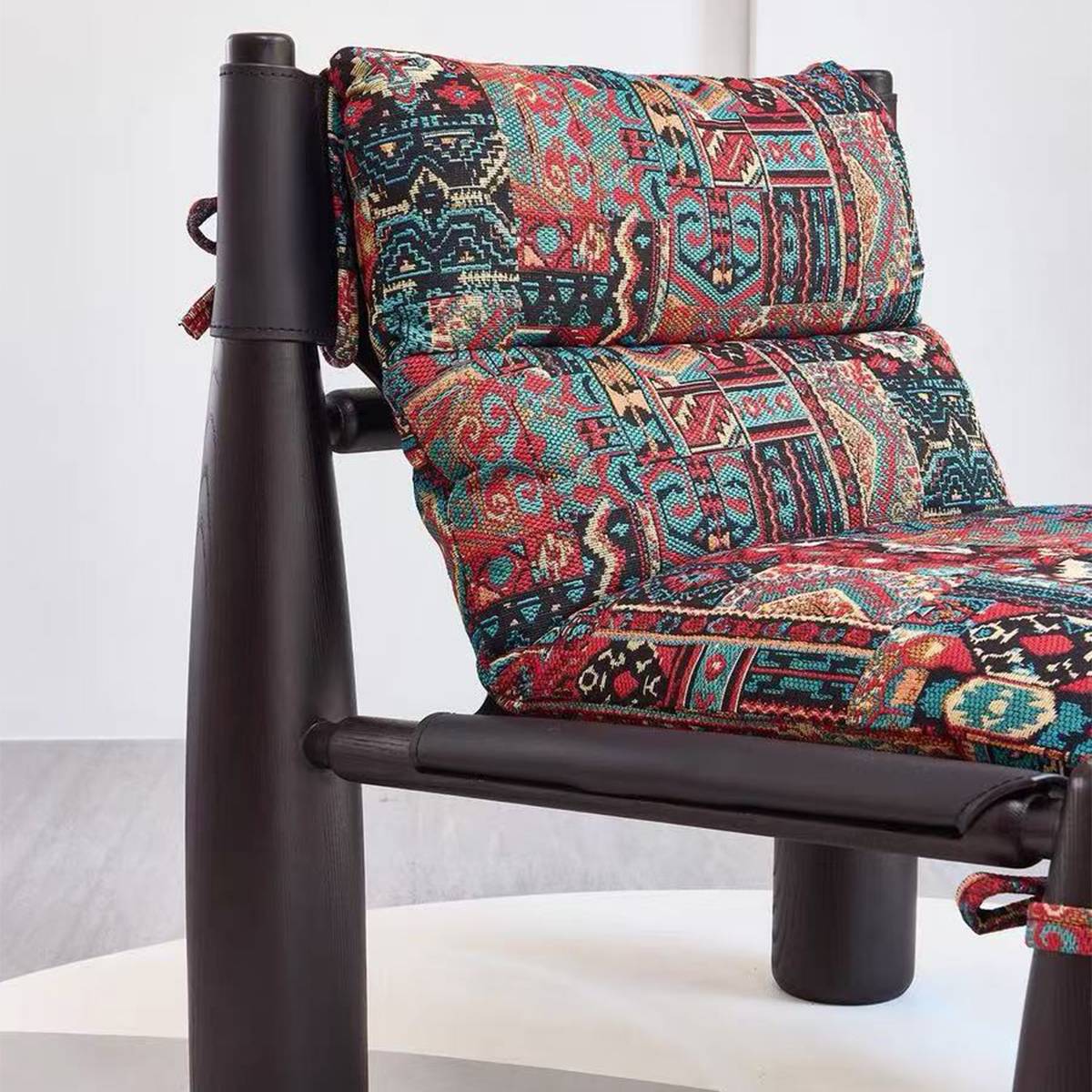 Close-up detail of the patterned fabric cushion and wooden frame