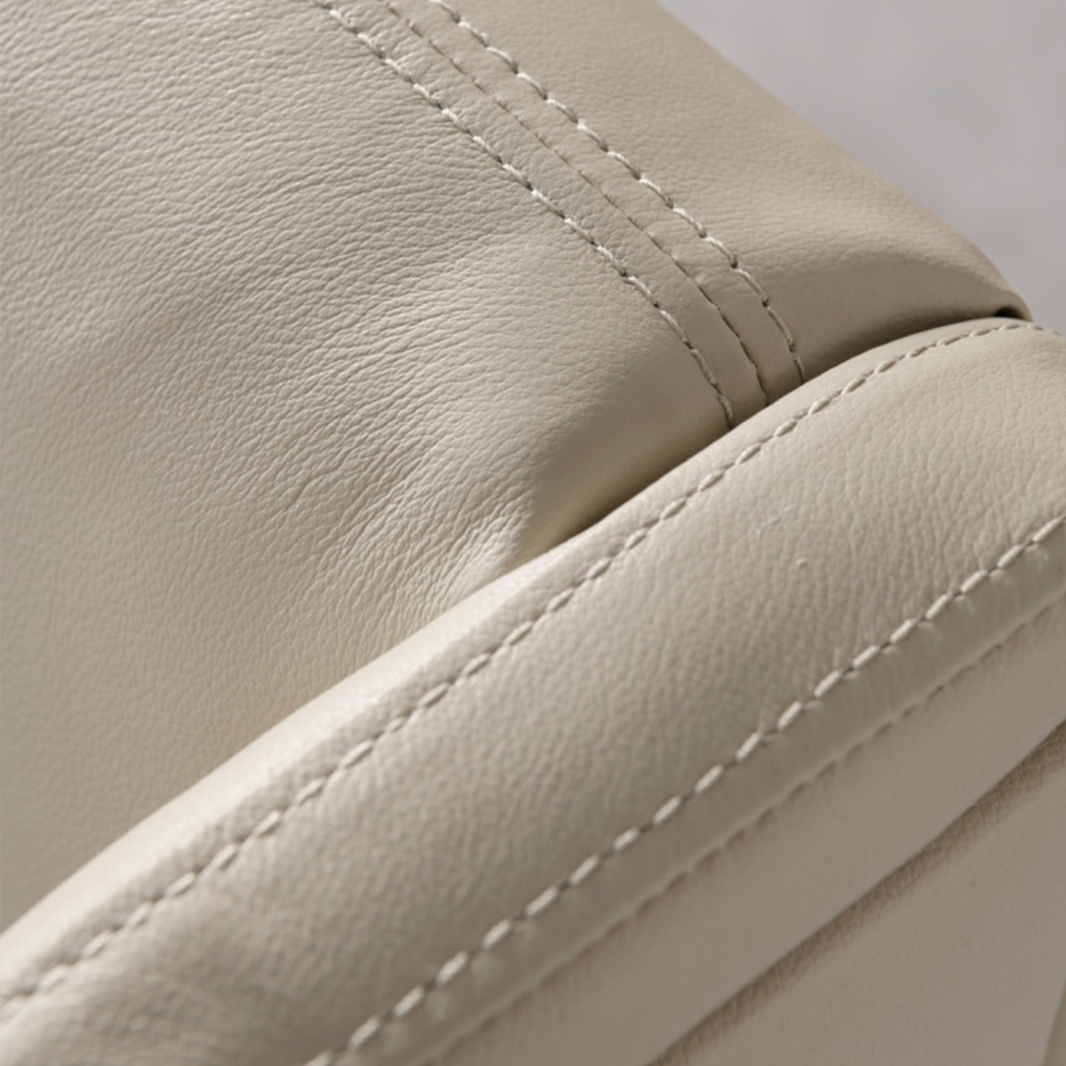 Detail shot of the leather texture and stitching on the bed frame