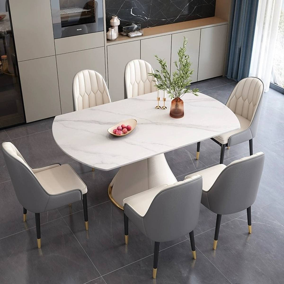 Dining table in oval configuration with dining chairs arranged around it
